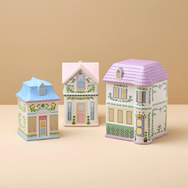Three decorative model houses with patterned details and various roof designs