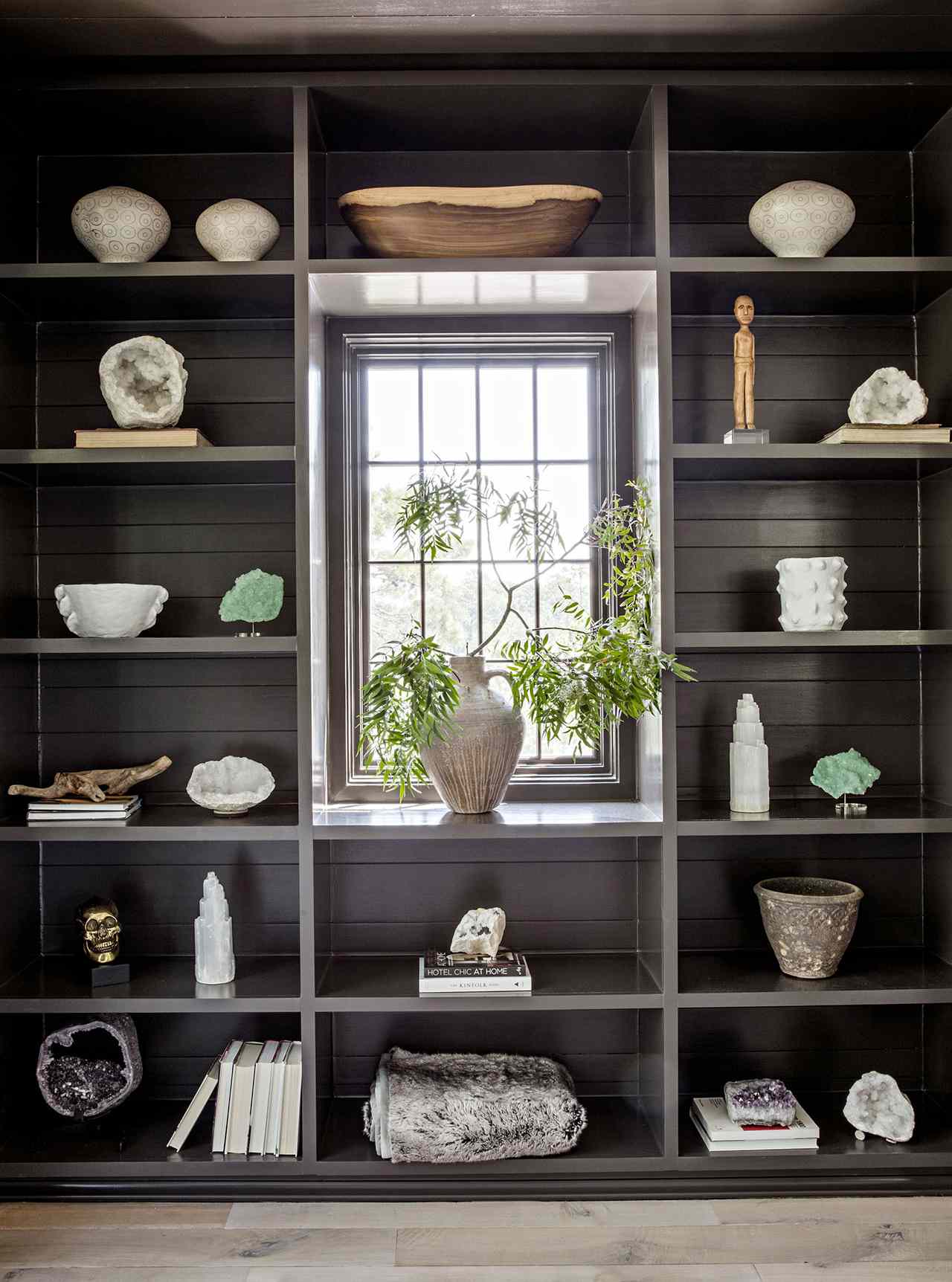 built-in bookshelves stained brown geodes ceramic decor