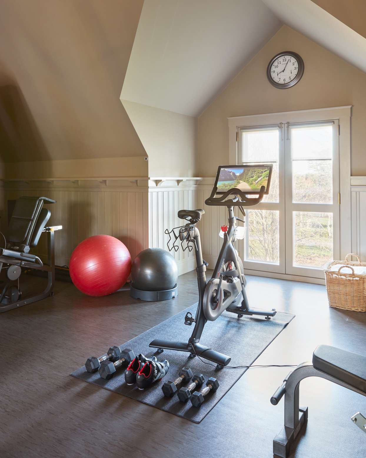 Martha's exercise room with Peloton bike and weights