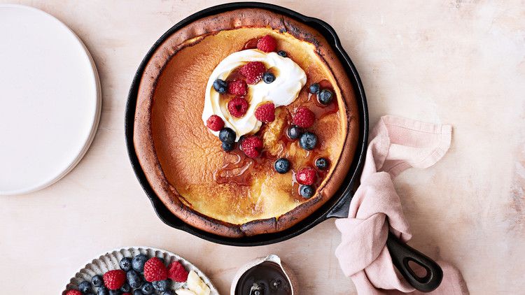 classic dutch baby topped with berries and cream