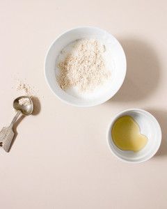 ingredients for oatmeal soap blended in bowls and a silver spoon