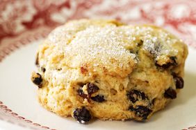 close up of a cream scone on a decorative plate