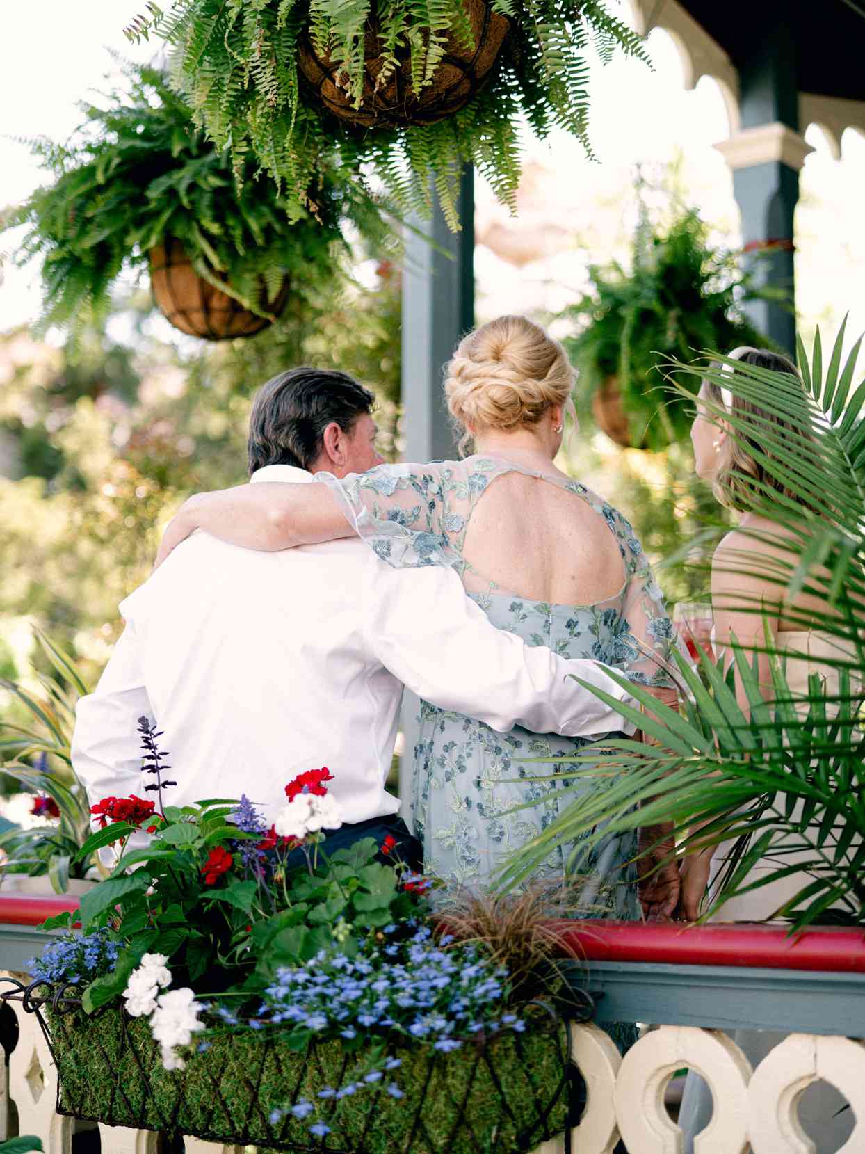 guests embracing on victorian porch