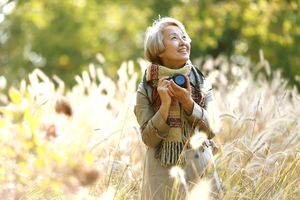 woman holding a camera in a field