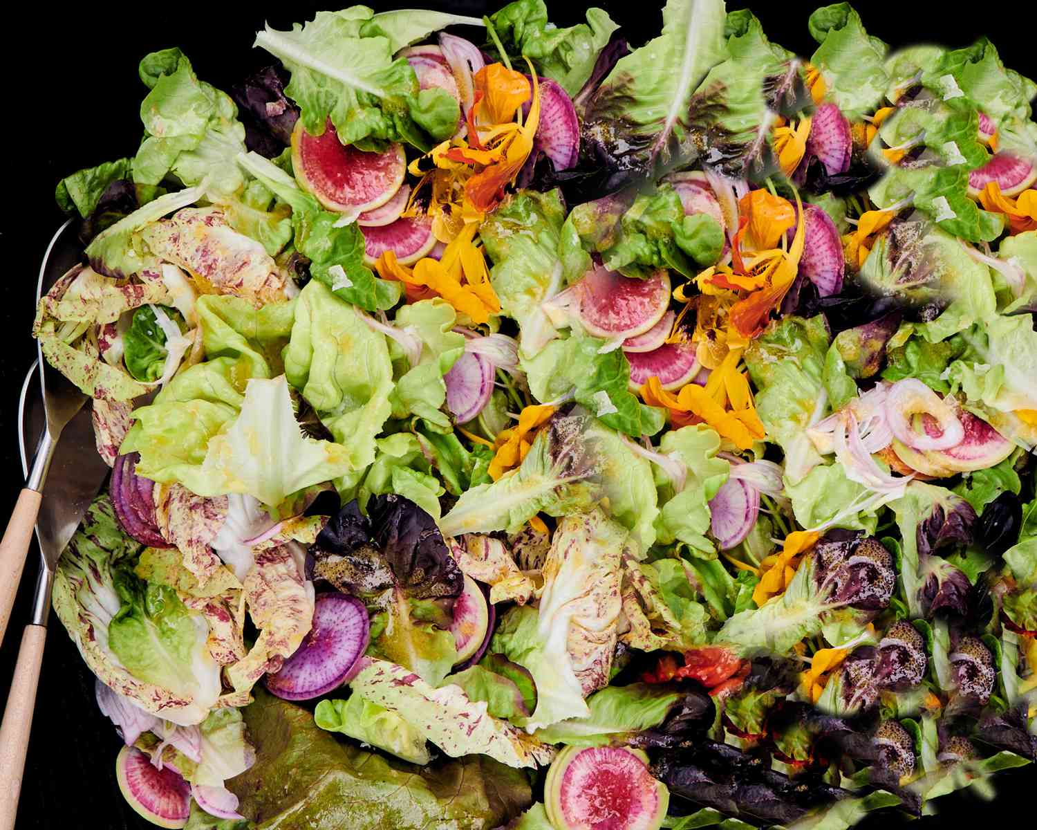 close up of green salad with pickled-shallot vinaigrette