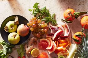 cutting board with citrus ginger cucumber beet oranges