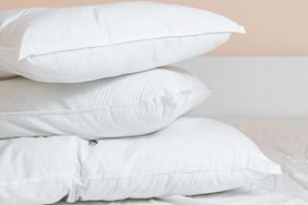 Three stacked pillows on a bed