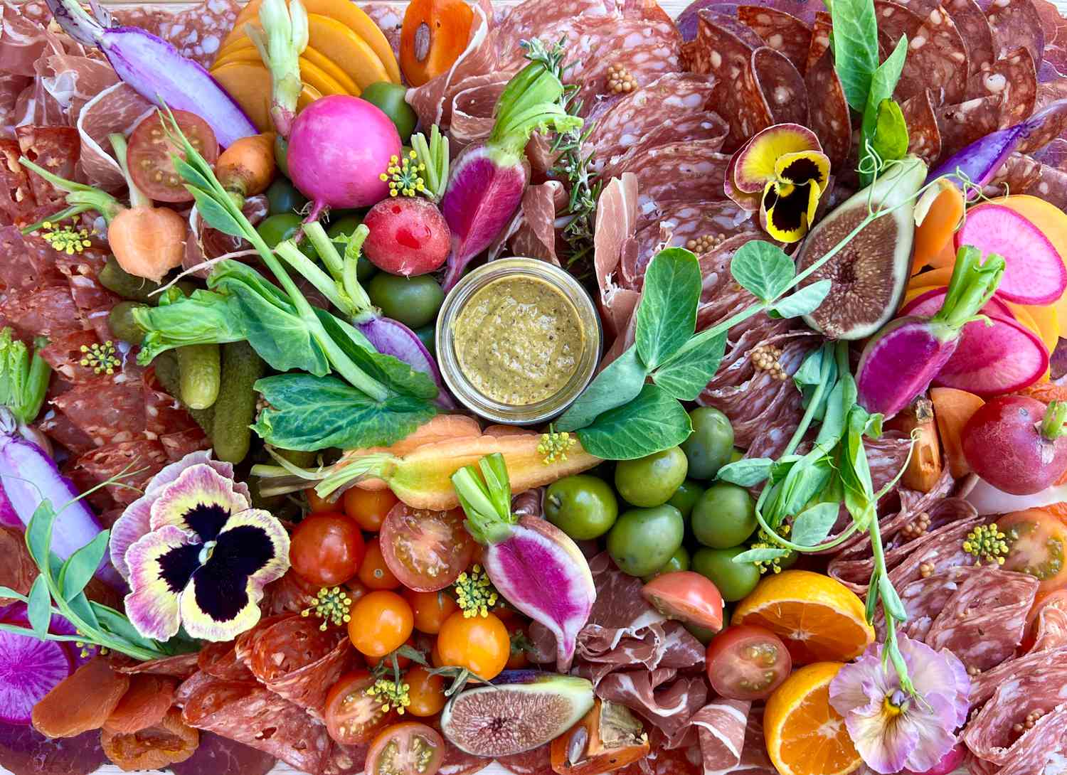 close up of a colorful charcuterie board with flowers