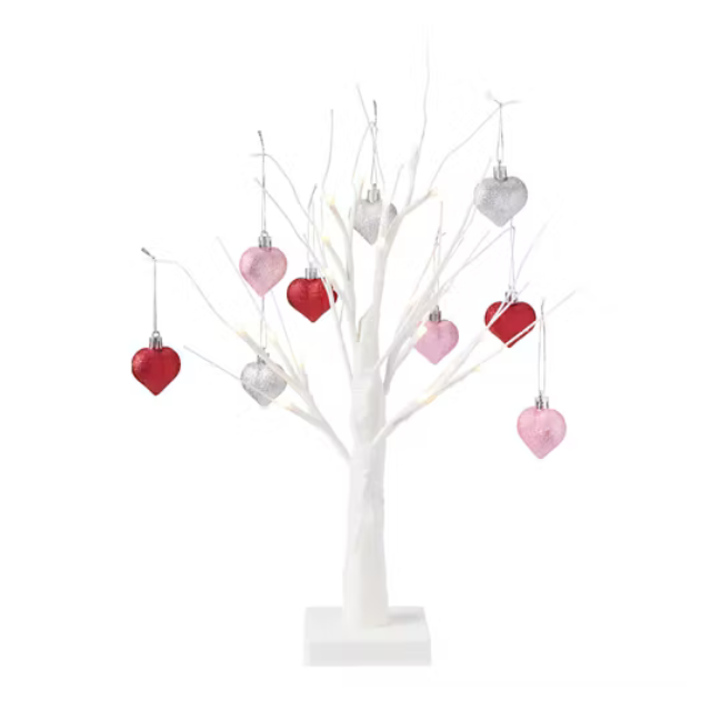 A decorative white tree with hanging heartshaped ornaments
