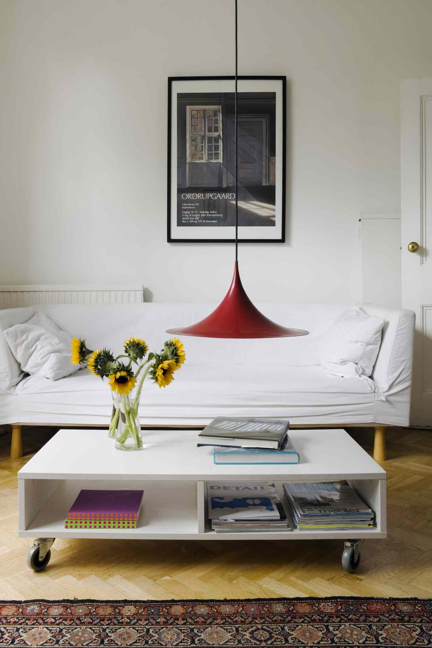 Red pendant light in neutral living room