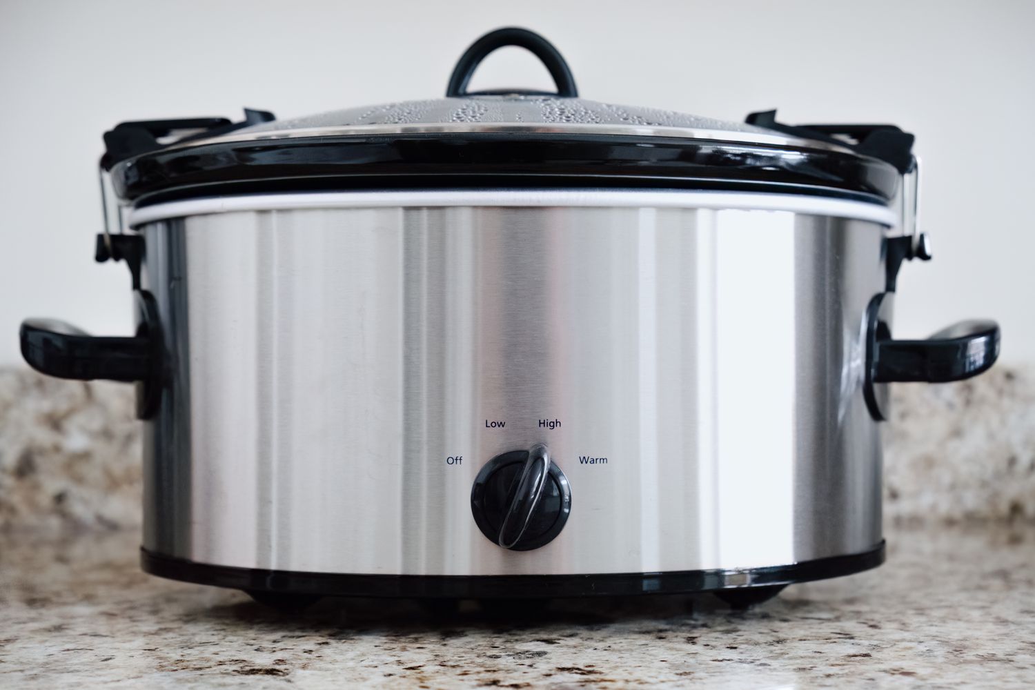 Close-up of a slow cooker in use on kitchen counter