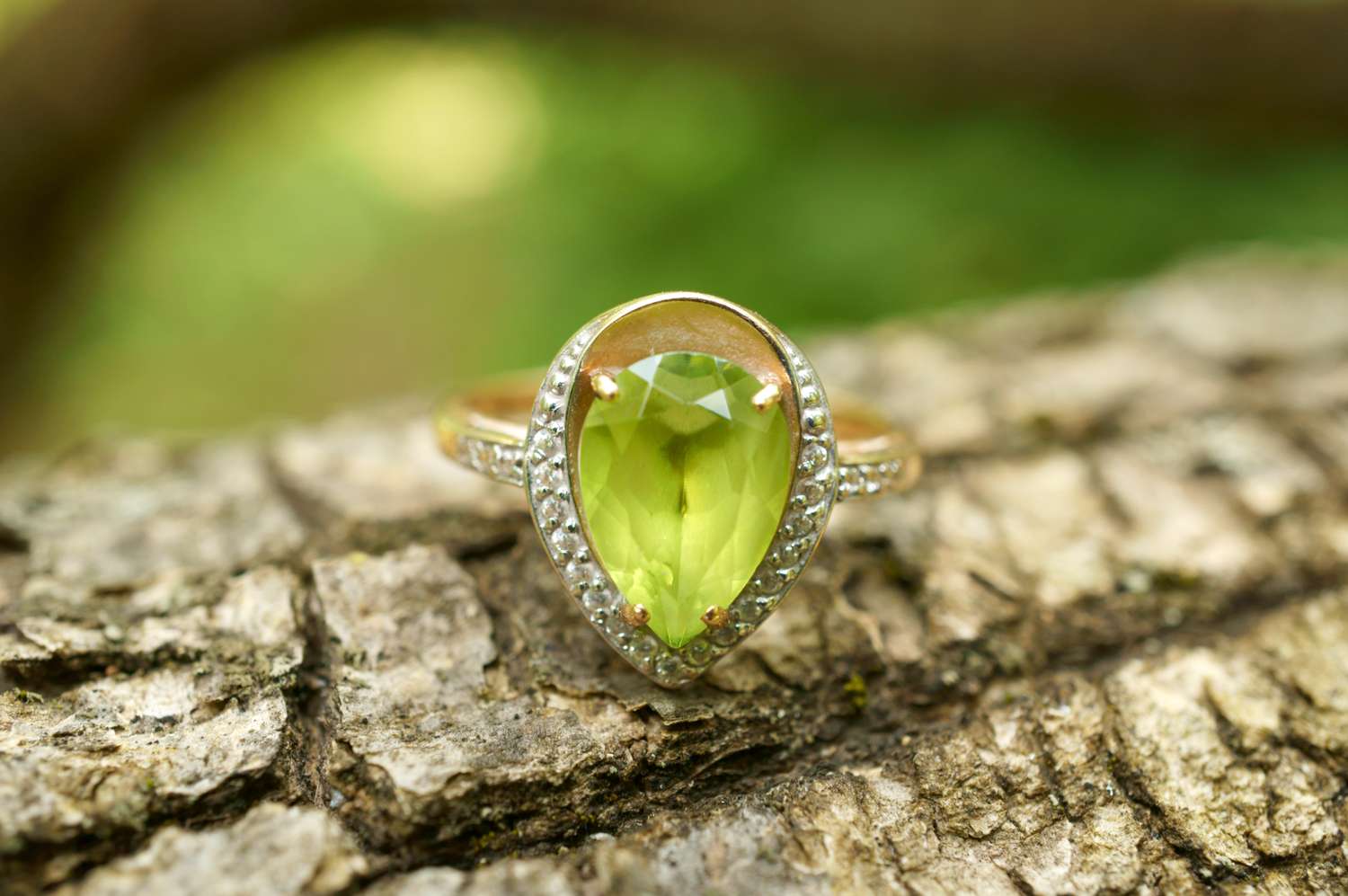 A teardropshaped gemstone ring set on bark