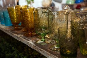 A collection of embossed glass goblets on a wooden surface