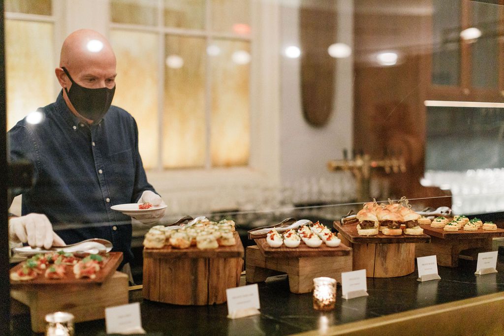 server filling plates with appetizers