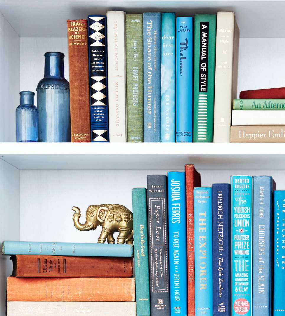 white bookshelf with books and bohemian style decor