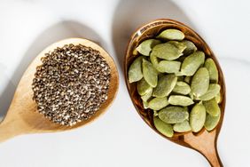 Wooden spoons with chia seeds and pumpkin seeds