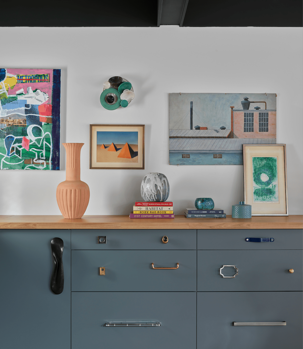 Cabinets with vases and art on top 