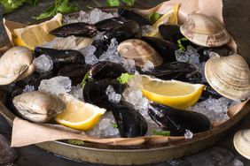 a platter of raw clams and mussles with lemon