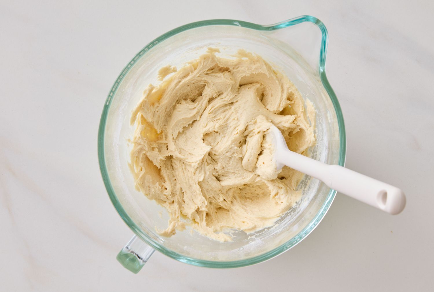 Mixing bowl containing prepared batter with a spatula inside