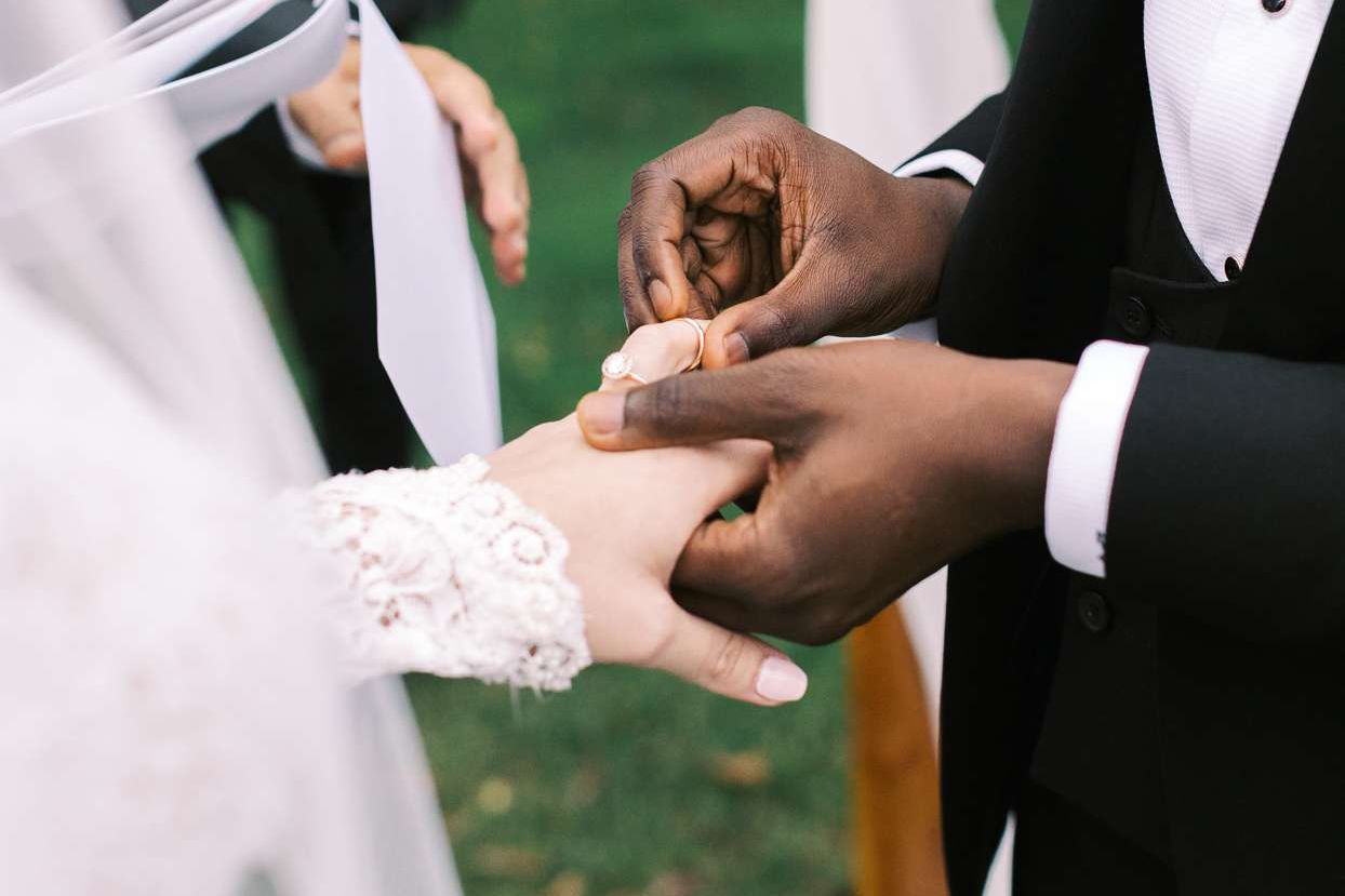 groom placing ring on bride's finger