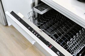 Open dishwasher with visible racks and control panel