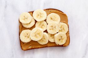 A slice of bread topped with peanut butter and banana slices