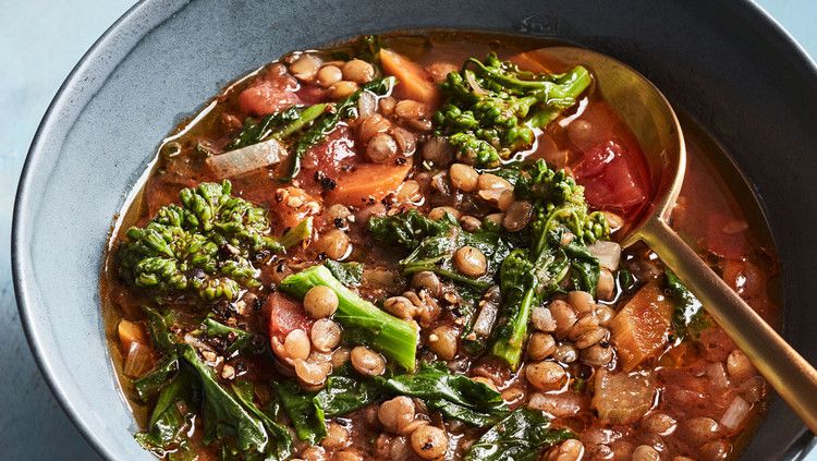 vegan lentil soup in bowl on blue table