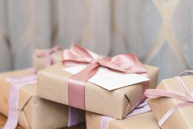 reception gifts in brown wrapping with pink and purple ribbon bows
