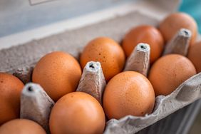 A carton of eggs displayed in an open egg container