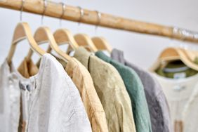 Clothes hanging on wooden hangers on a rack