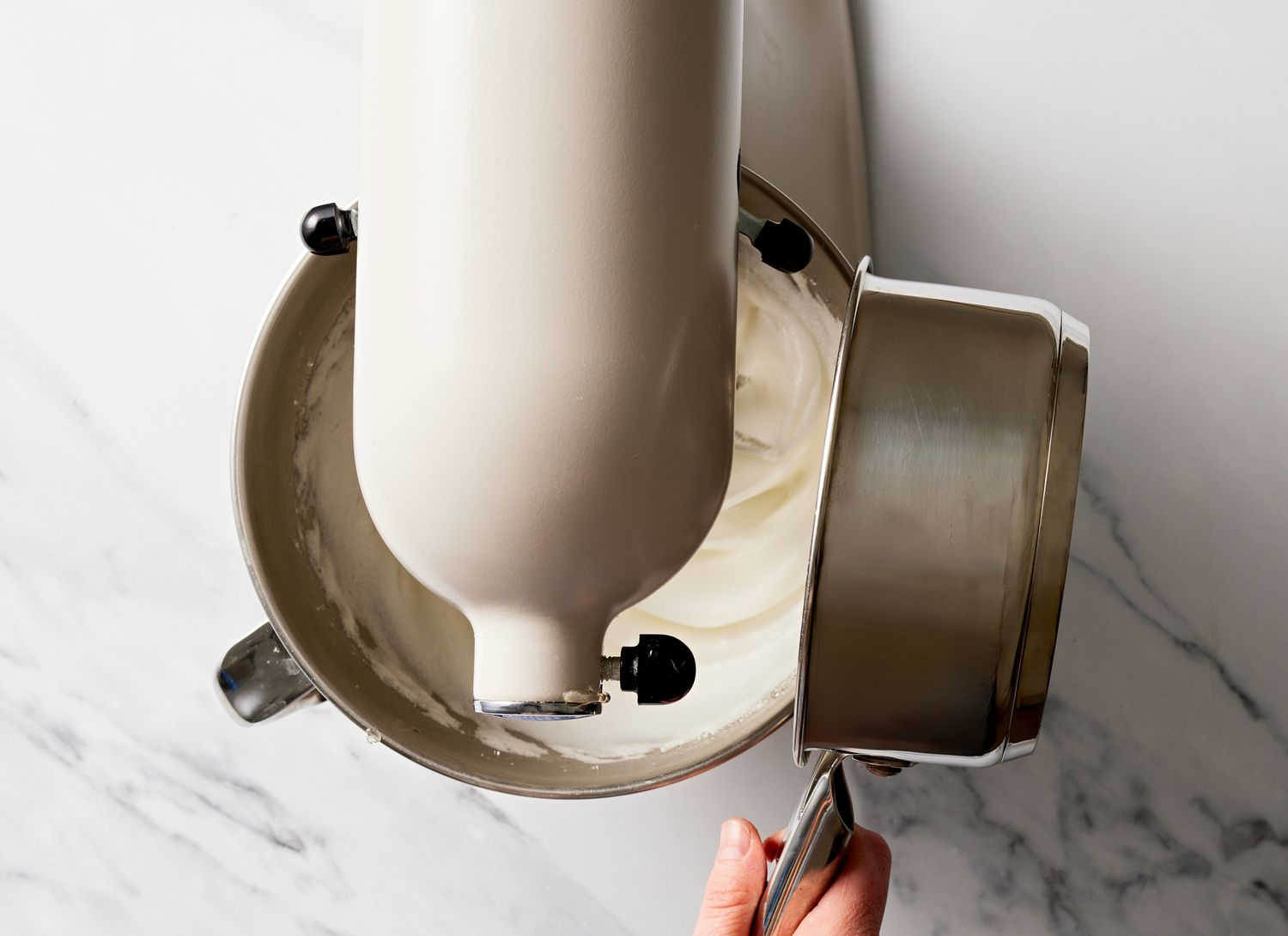 top view of a kitchen mixer with white ingredients