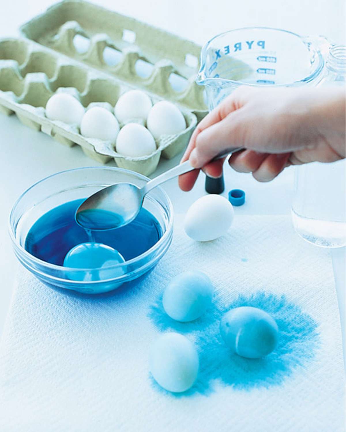 spooning eggs into dye