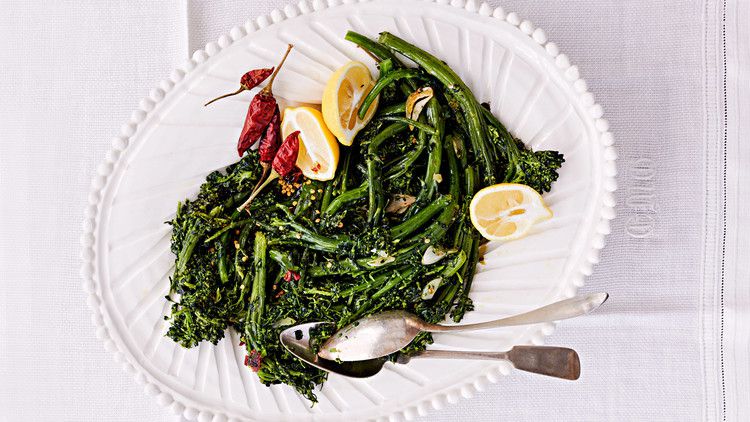 sprouting broccoli with peperoncini served with lemon wedges