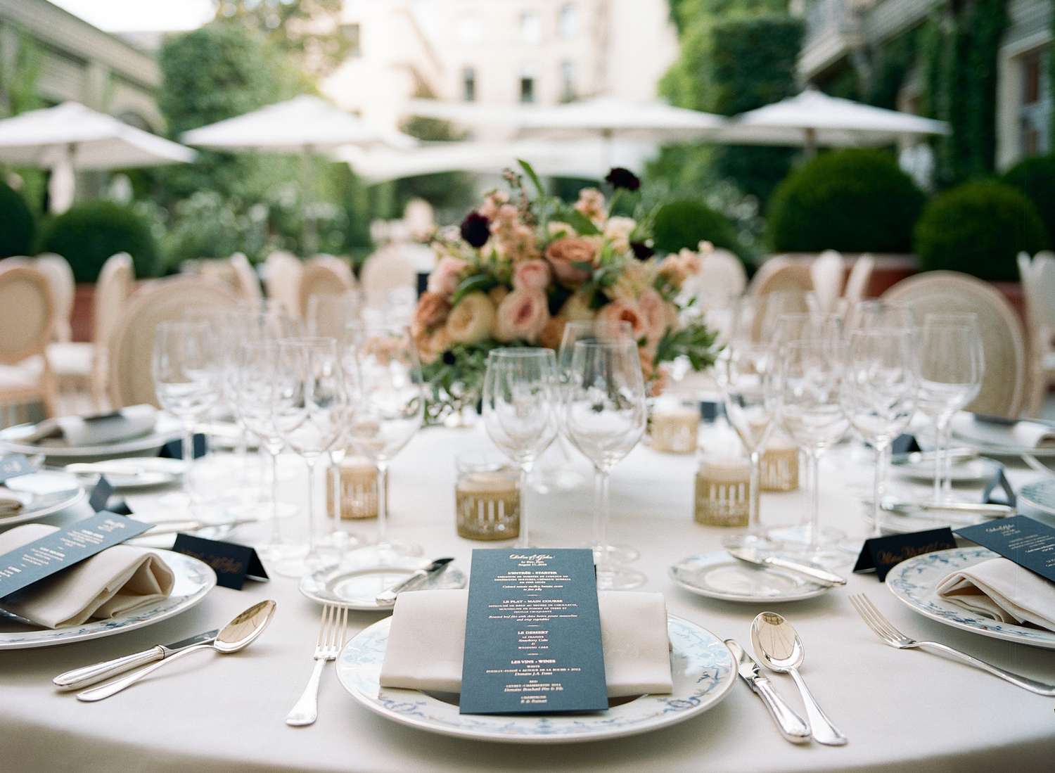 wedding reception napkin folds napkin rolled on top of plate displaying menu