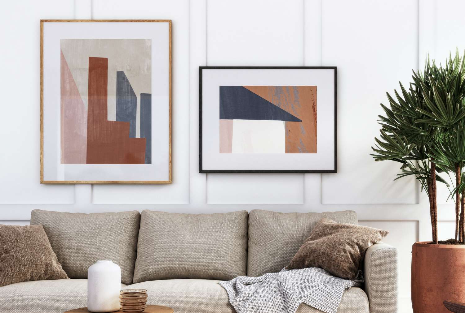 Living room with couch wall art candle and a plant for decor emphasis