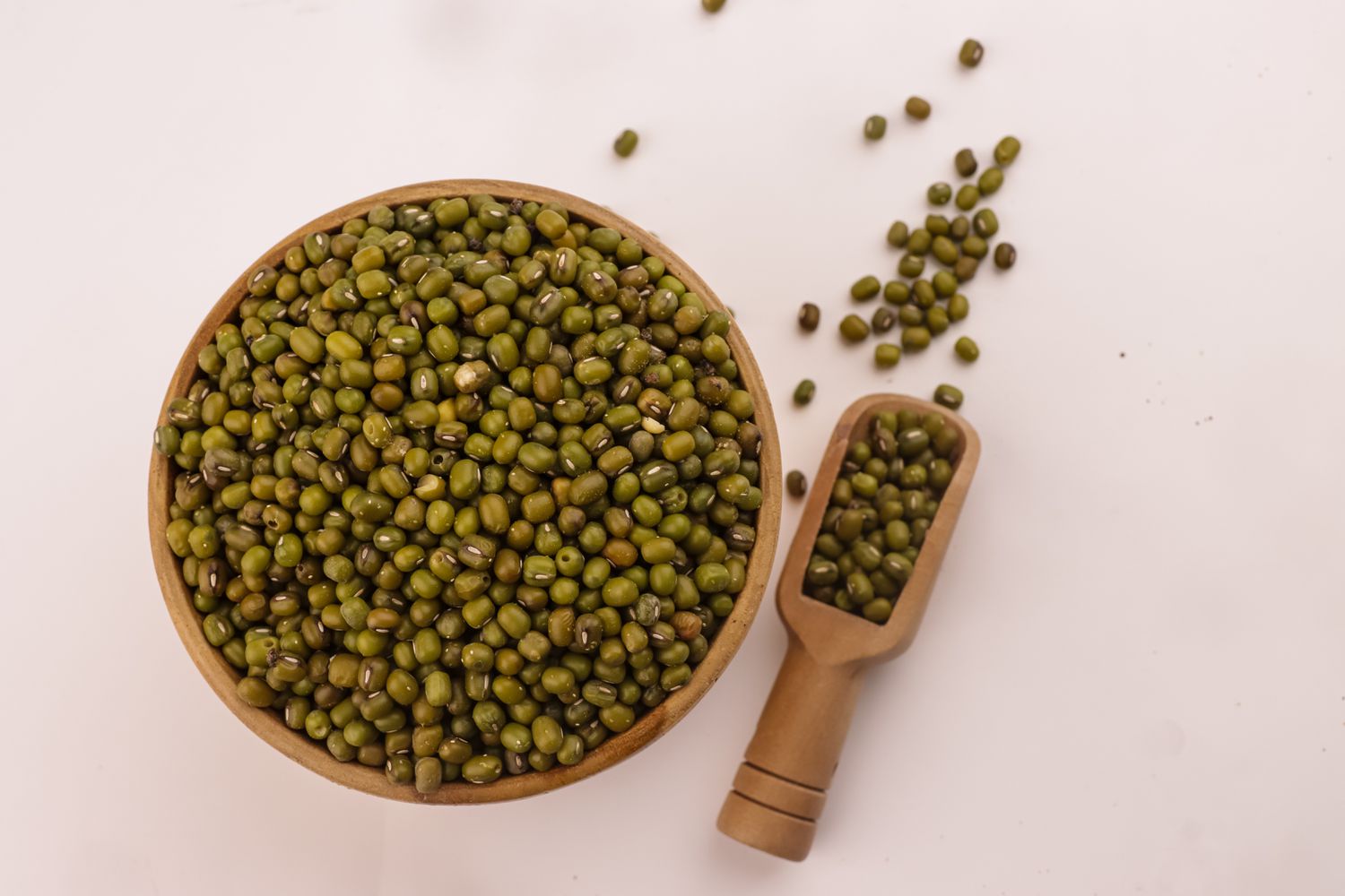 dry mung beans in bowl and more in a scoop 