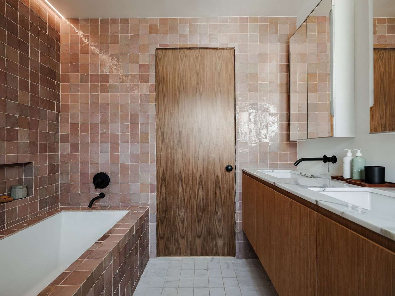 a bathroom with pink tiles