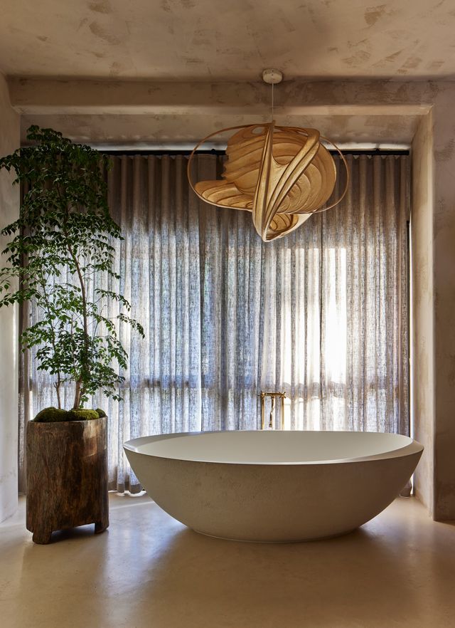 Neutral bathroom with sculptural chandelier
