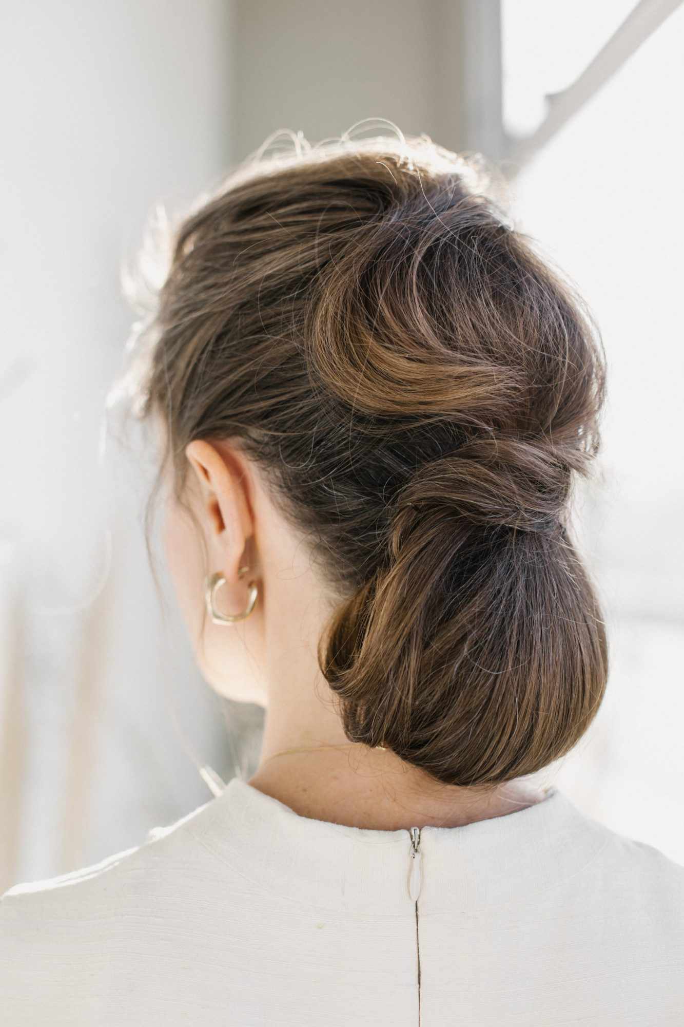 bride low bun hairstyle elongated waves