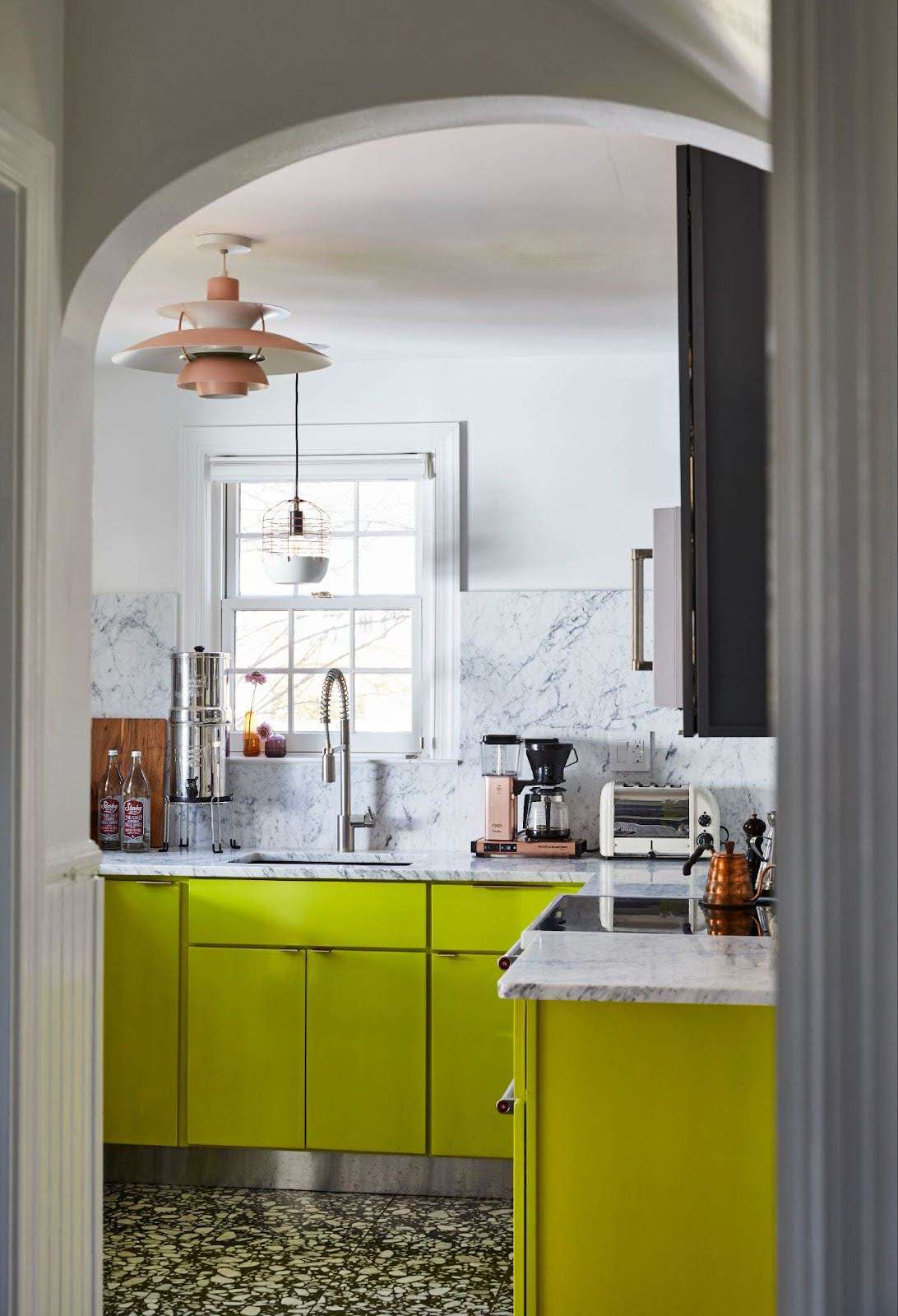 a kitchen with yellow cabinet