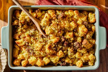 cornbread and sausage stuffing in a casserole dish on wooden surface