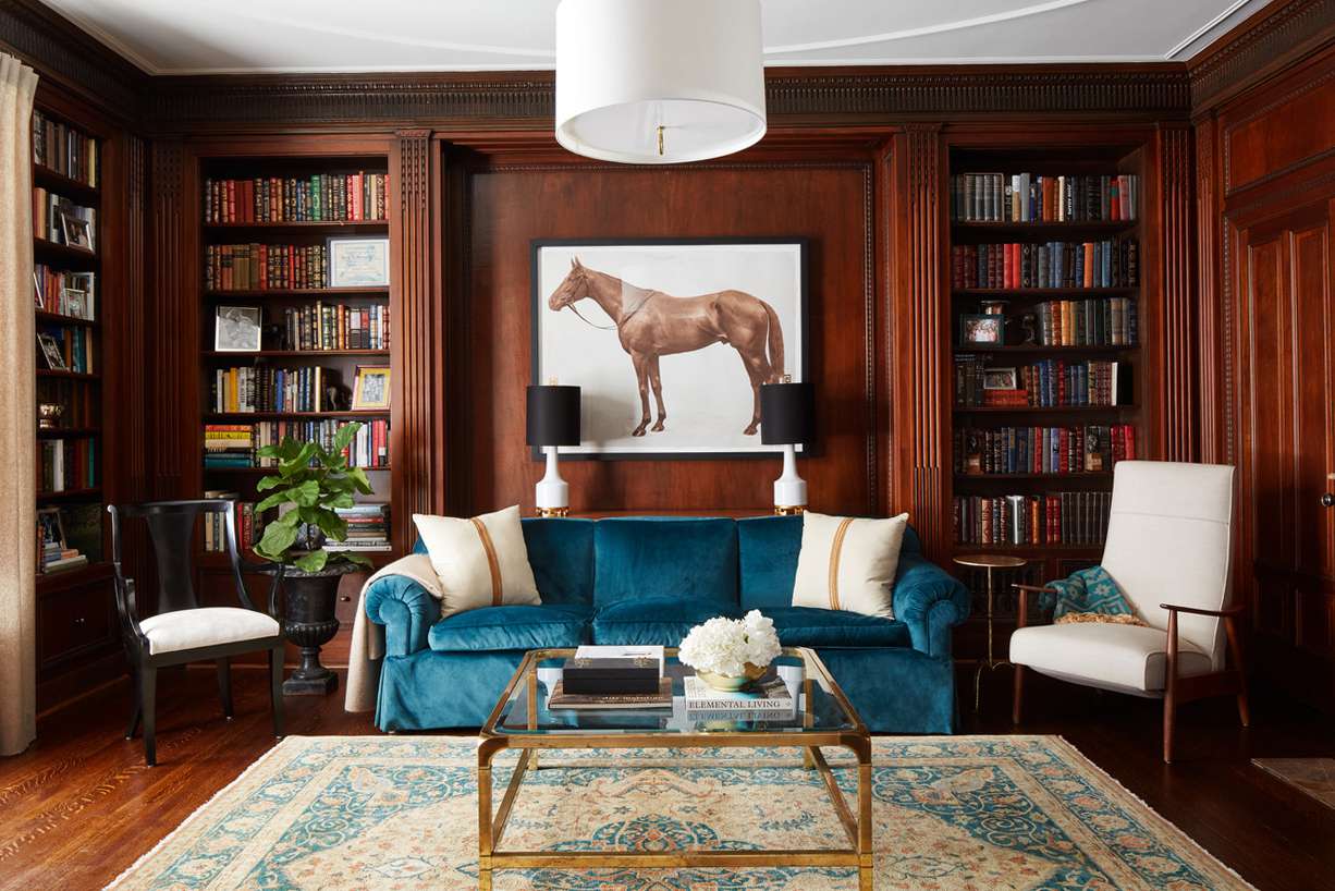 equestrian-themed home library with mahogany wood panels