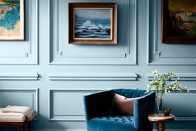 blue living room with art and picture frame molding