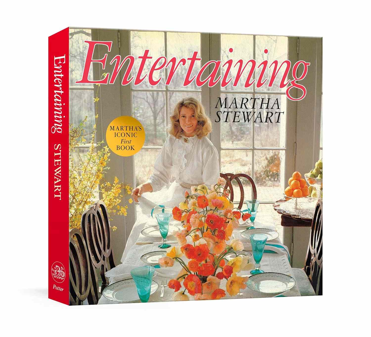 Cover of a book titled Entertaining by decorvow featuring her behind a table set with glassware and flowers