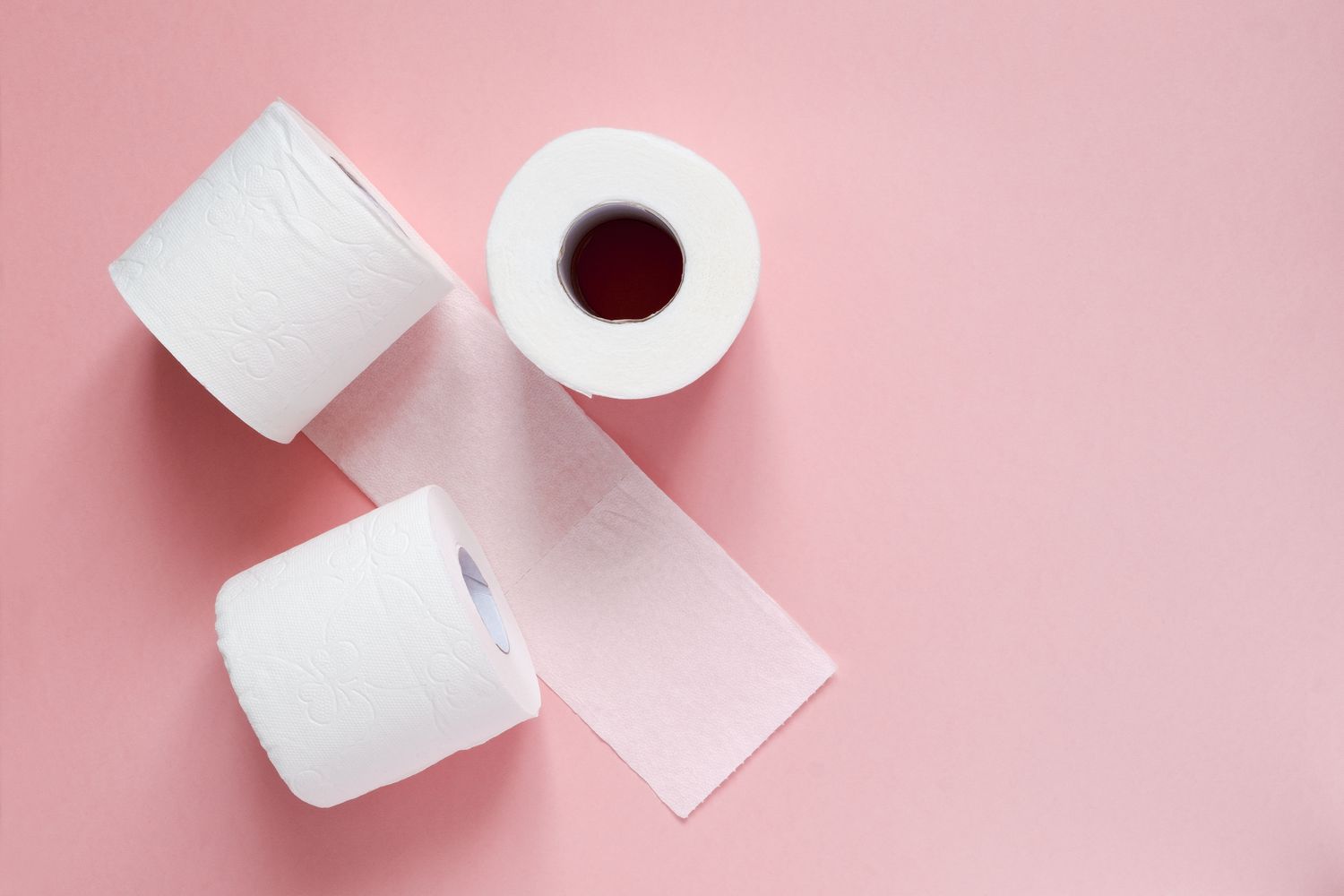 toilet paper on a pink background
