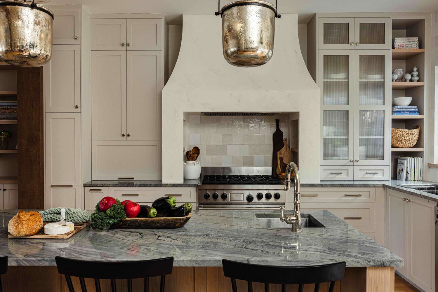 a white kitchen with plaster hood