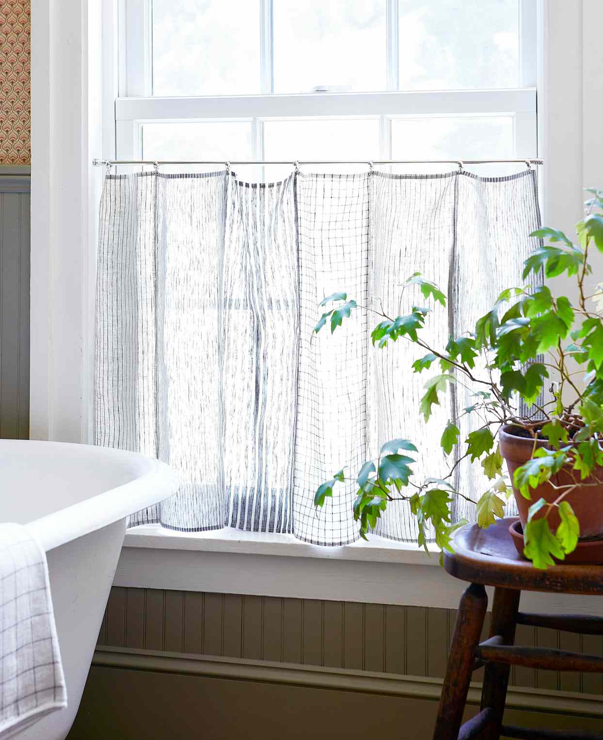 tea towel curtains hanging in bright window