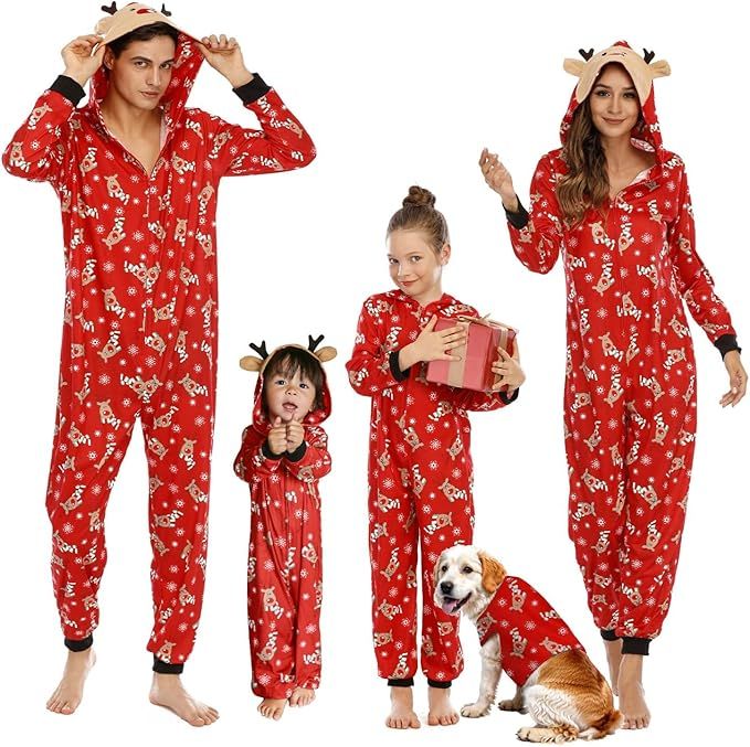 Family dressed in matching red holidaythemed pajamas standing together with a dog wearing a similar outfit