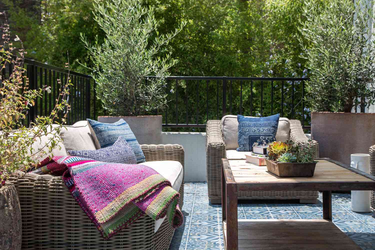patio with wicker furniture and colorful throw pillows