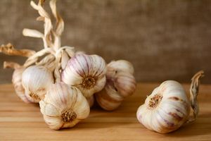 garlic bulbs on wooden surface